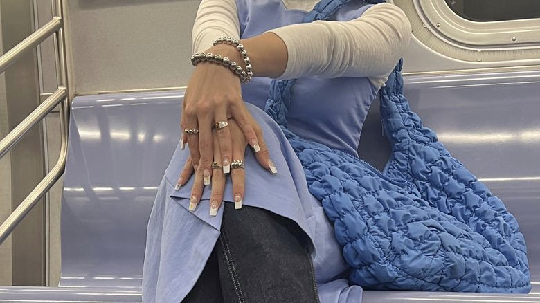 woman wearing blue hobo bag