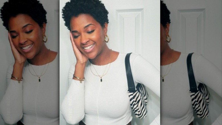 black woman hand to face zebra print purse