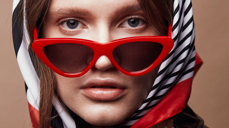 Model wearing red cat eye glasses