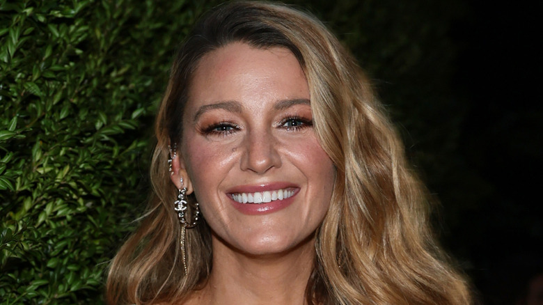Blake Lively smiling in a spaghetti-strap dress