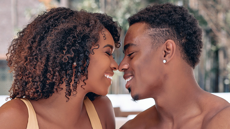Smiling Black couple about to kiss