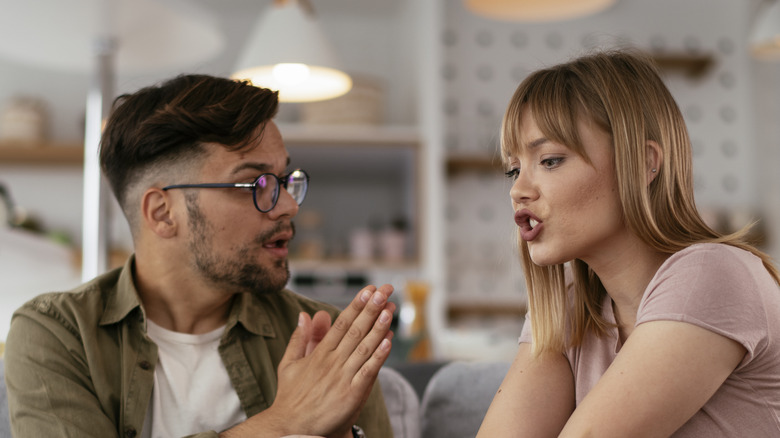 couple sitting on the couch having a fight