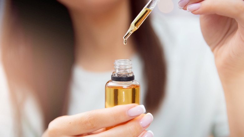 woman holding castor oil