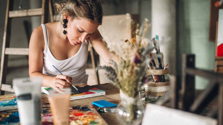 woman with earrings painting