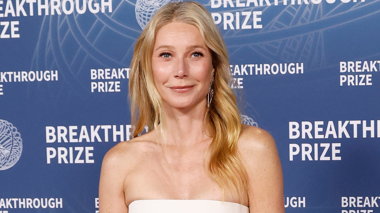 Gwyneth Paltrow in a white sleeveless dress poses for a picture at the Breakthrough Prize Ceremony