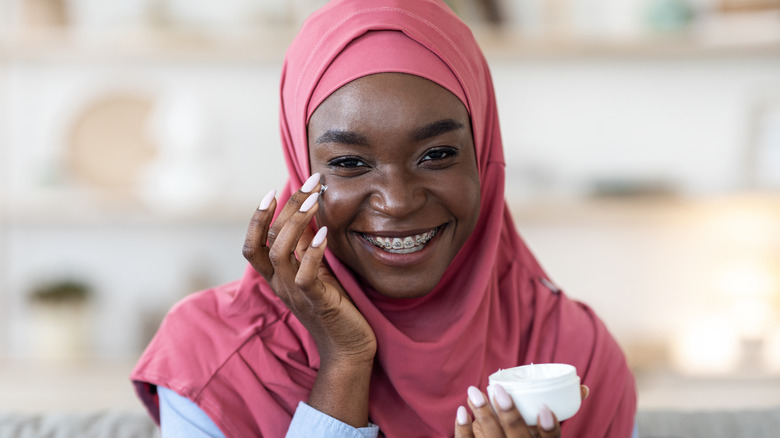 Applying face moisturizer