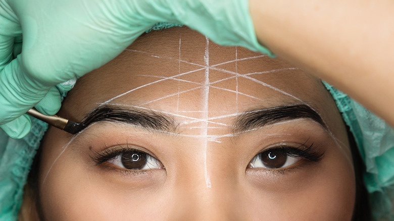 Asian woman getting eyebrows tinted