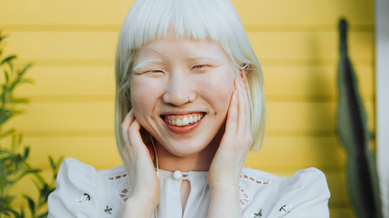 Smiling woman with nostril piercing