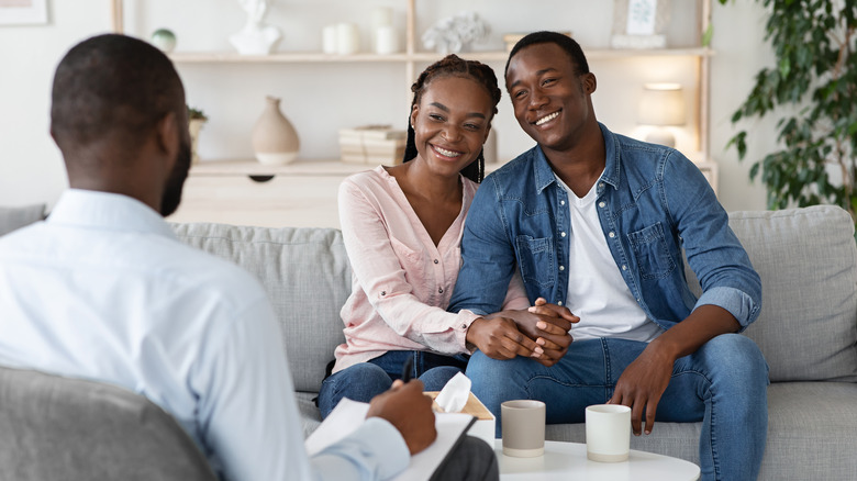 Couple holding hands during therapy
