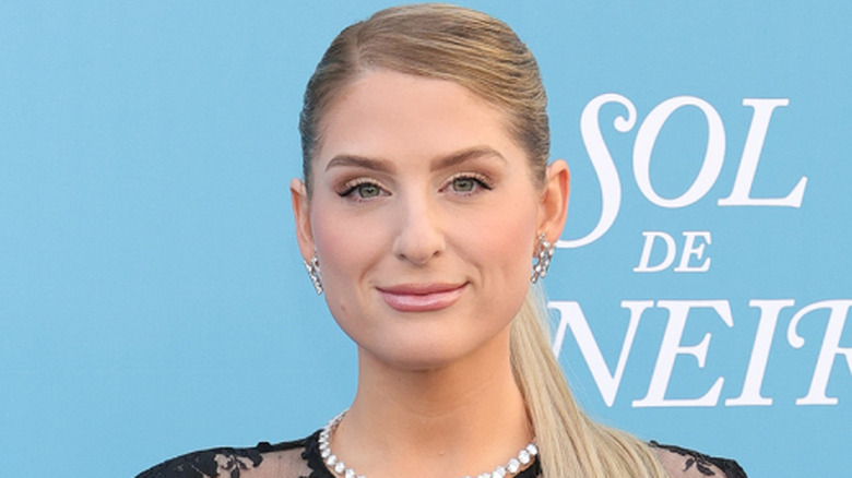 Meghan Trainor wearing a black dress and smiling