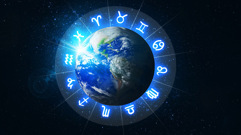 earth surrounded by the zodiac signs