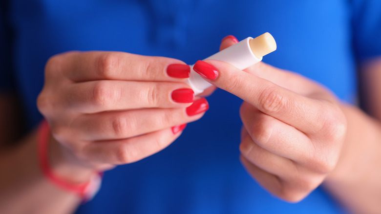 woman holding sunscreen stick