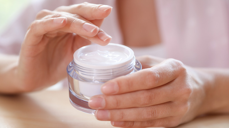woman holding moisturizer