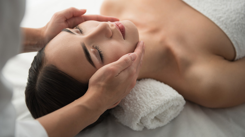Woman receiving facial massage