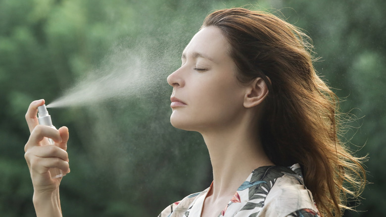 A woman using facial spray
