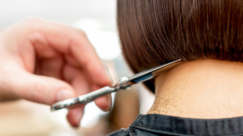 scissors cutting medium-length hair