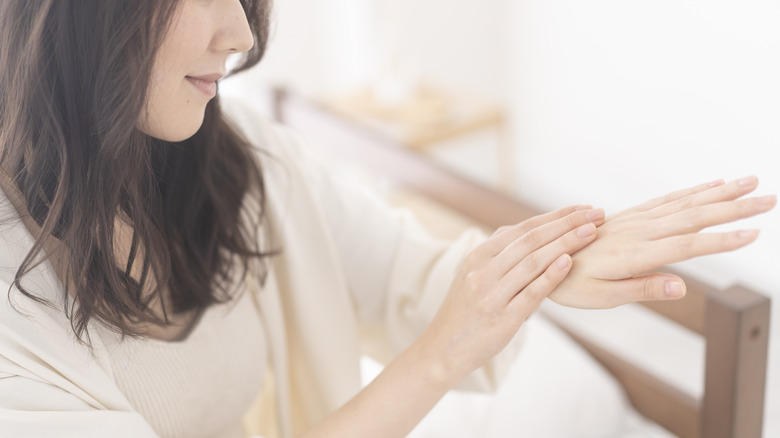 Woman looking at her clean fingernails