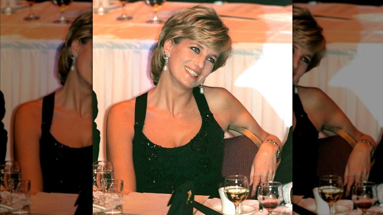 Princess Diana smiling at table