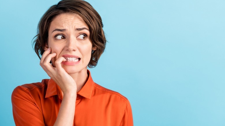 Stressed woman biting her nails