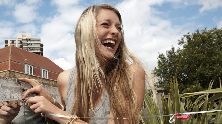 Blond woman laughing