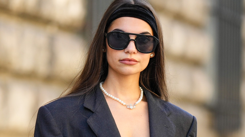 Girl wearing Vivienne Westwood pearl necklace.