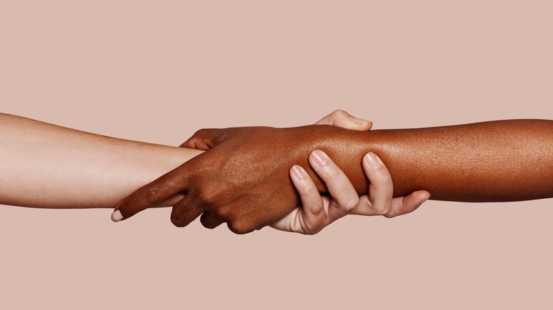 two hands holding each other 