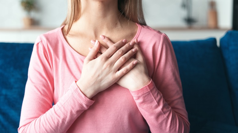 Woman with hands on heart