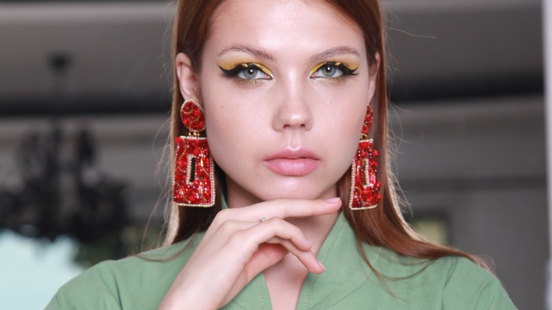 woman wearing statement earrings