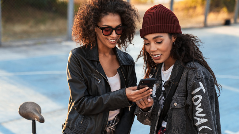two African American women wear black and grey jackets