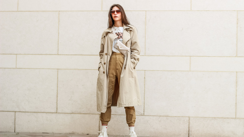 woman wearing a trenchcoat and cargo pants
