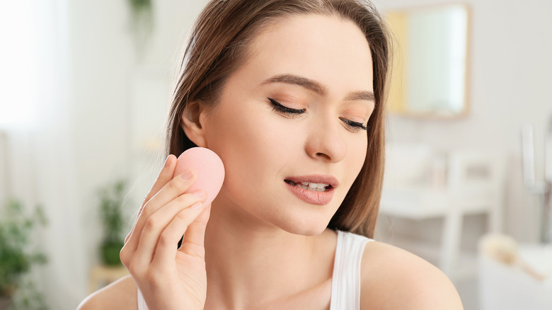 Woman doing her makeup