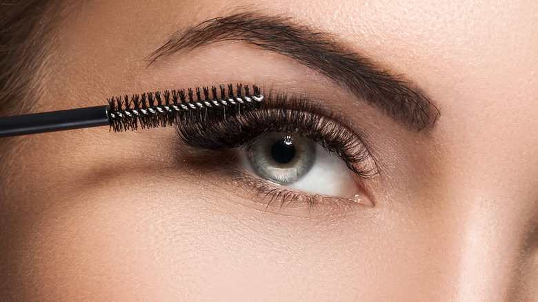 Woman applying mascara