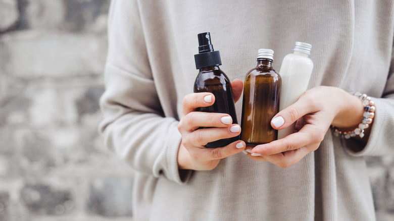 Woman holding various face products