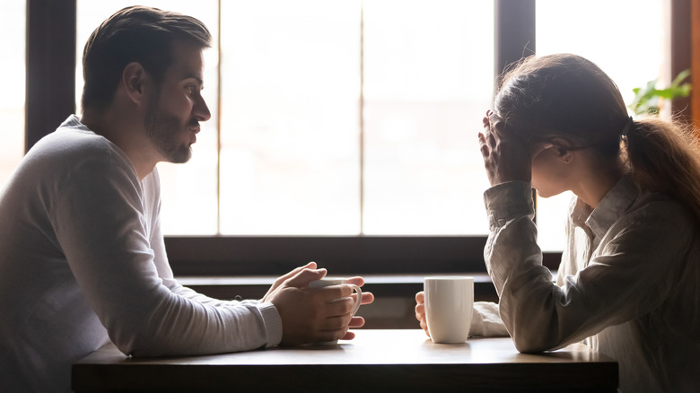 Friends have a serious conversation over coffee 