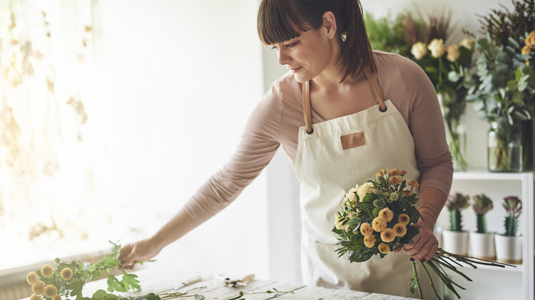 woman arranging flowers