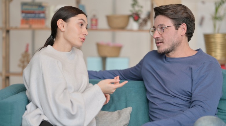 Woman explaining herself to man