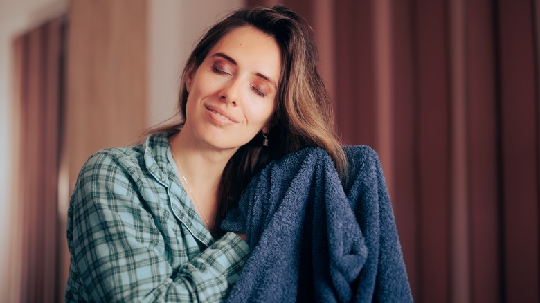 A woman drying her hair with a towel