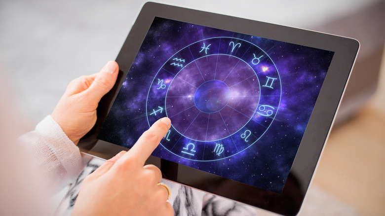 woman reading horoscope app