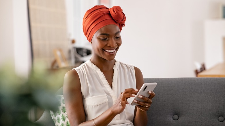 woman texting with a smile