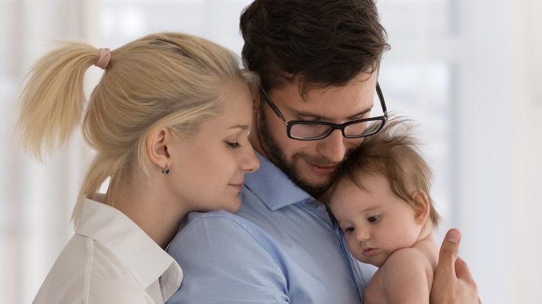 couple holding baby