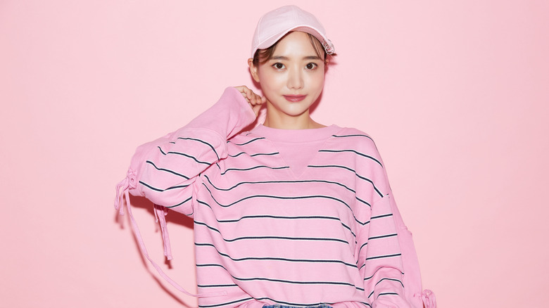 woman wearing a bright pink striped shirt