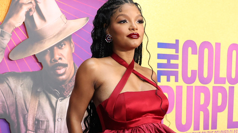 Halle Bailey wearing red gown and lipstick