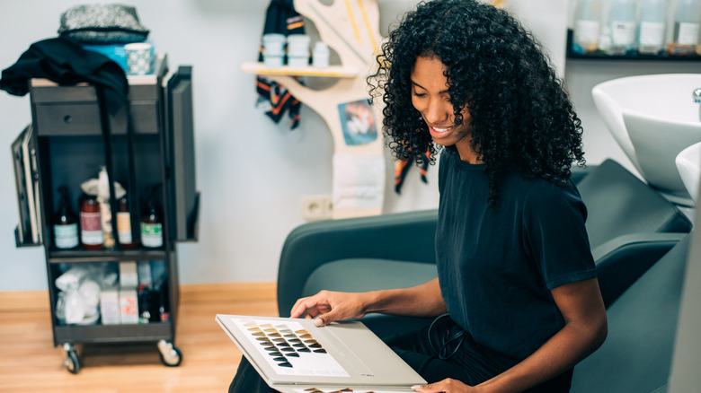 A woman with dark hair in a salon