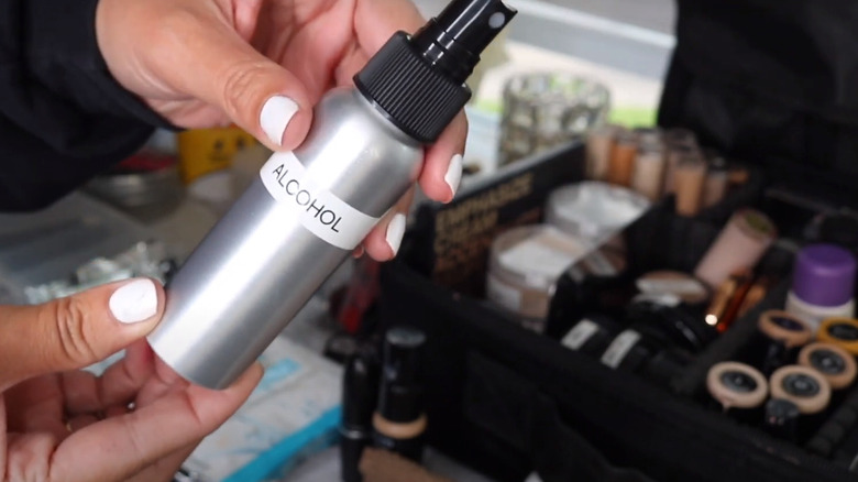 Woman using spraying bottle