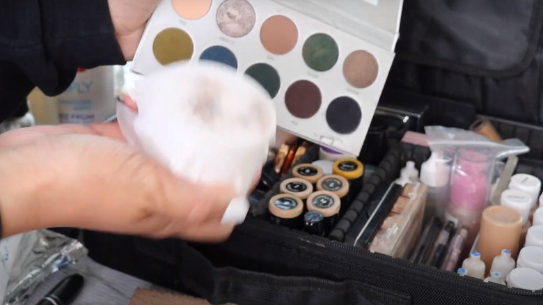 Woman wiping makeup palette