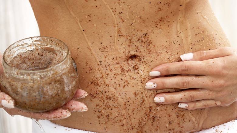 woman using sugar scrub