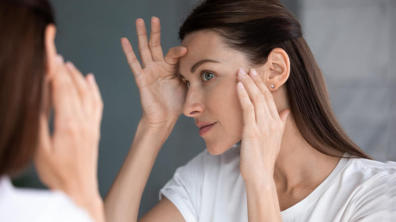 Woman examining face