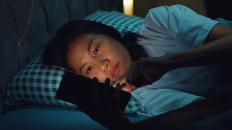 woman in bed with phone