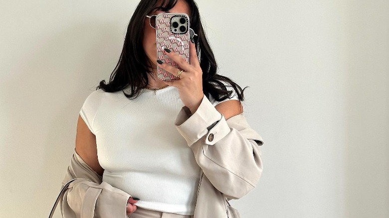 Person in white T-shirt and beige jacket