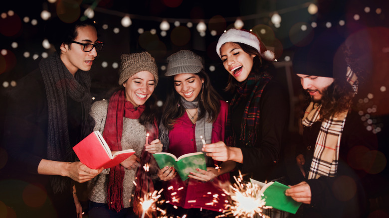 Happy holiday carolers singing